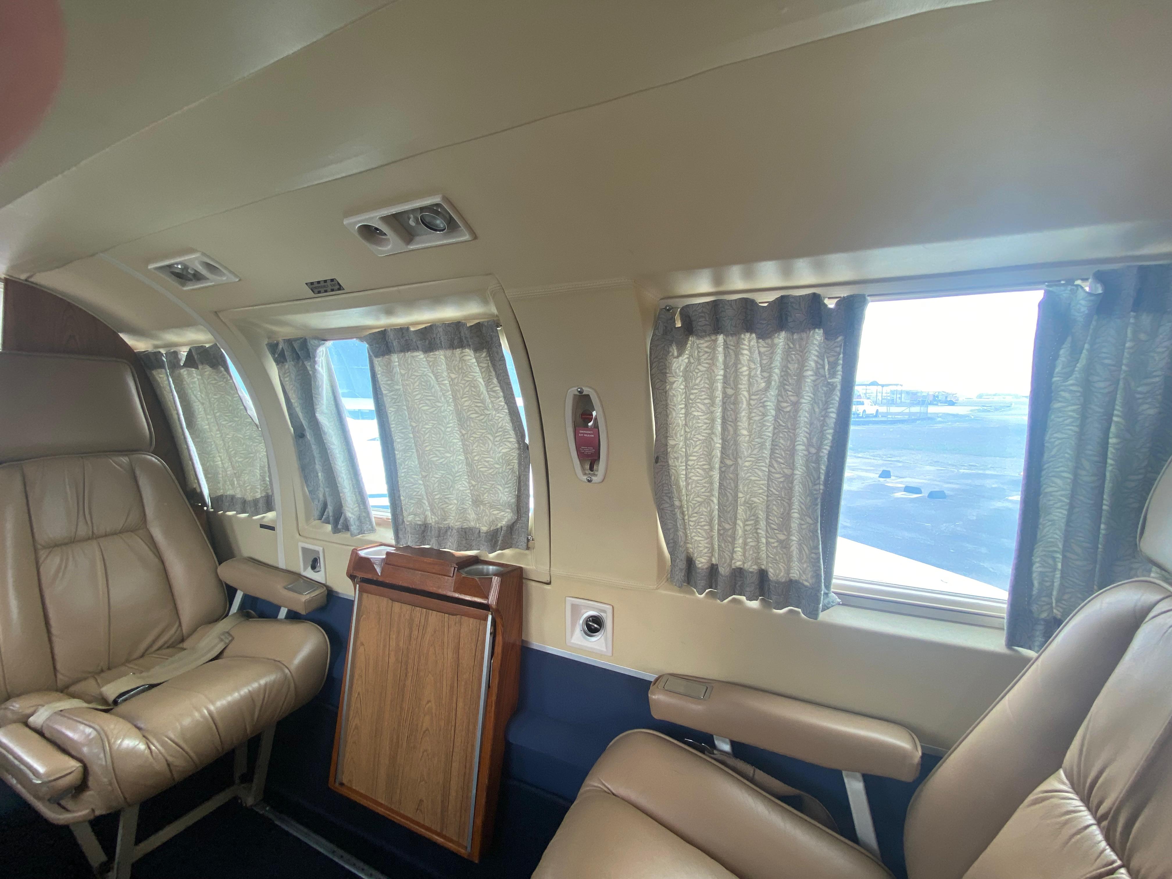 Navajo passenger cabin with curtained windows and cabin table