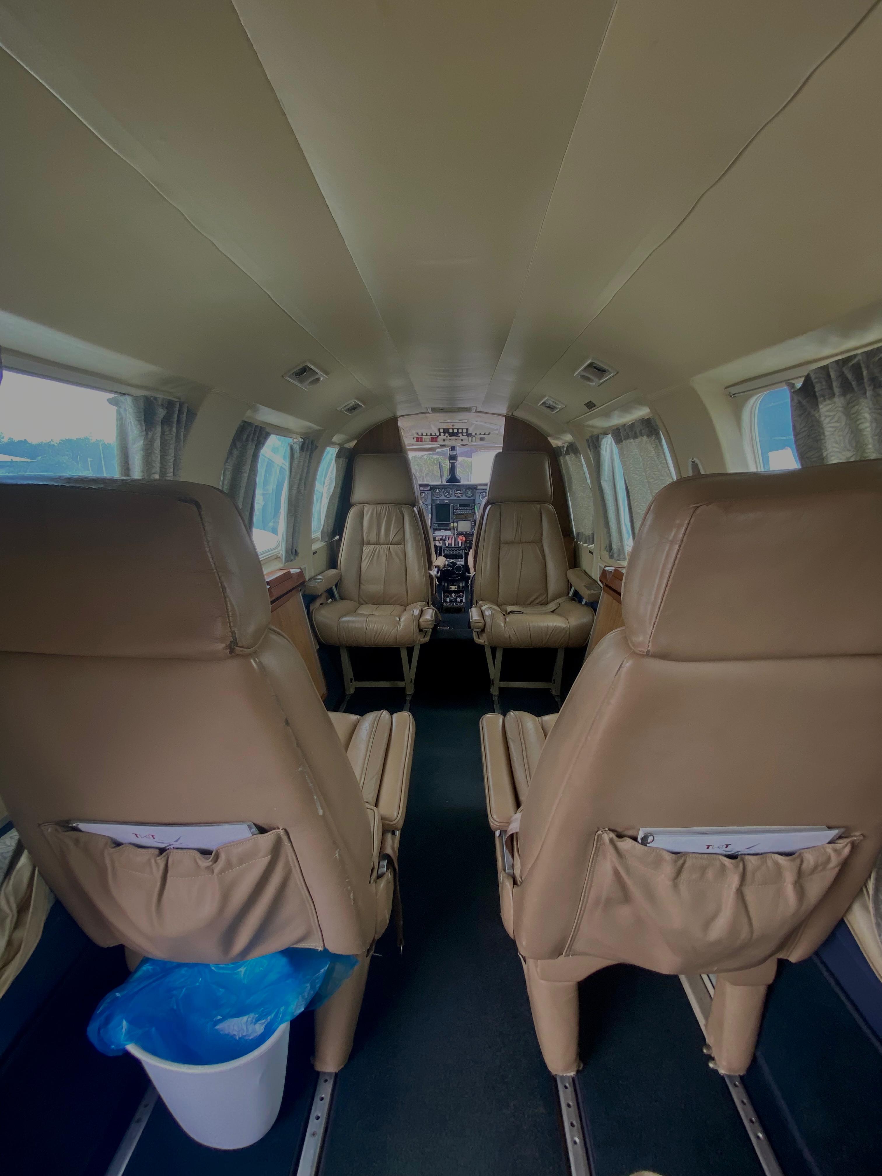 Six-seat club cabin aboard the PA-31 Navajo, facing the cockpit